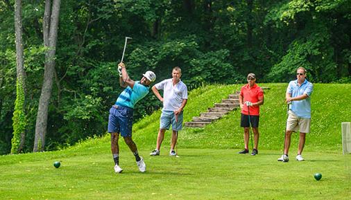 Golfers on golf course teeing off